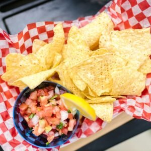 Enjoy crispy nachos served with fresh, colorful pico de gallo and a slice of lemon.